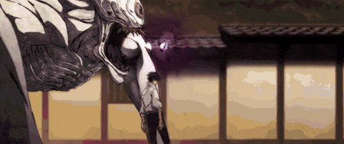 a man is standing in front of a large monster