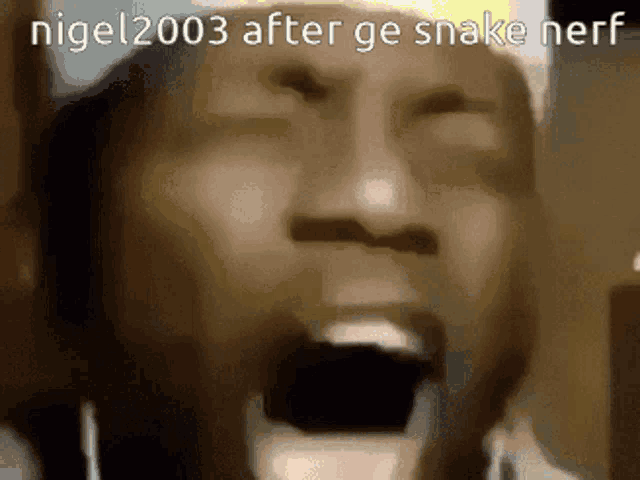 a close up of a man 's face with his mouth open and the words nigel 2003 after ge snake nerf on the bottom