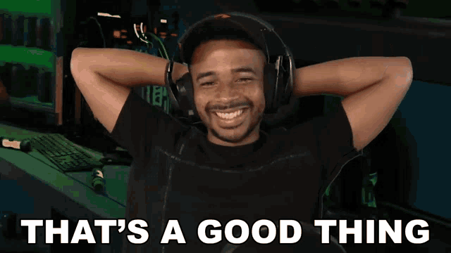 a man wearing headphones is smiling with the words that 's a good thing below him
