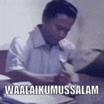 a man is sitting at a desk writing on a piece of paper with the words waalaikumussalam above him .