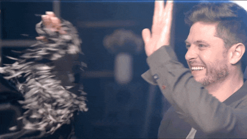 a man is giving a high five to a woman