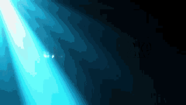 a blue light shines through a dark background