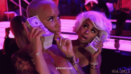 a group of women are holding stacks of money in their hands .
