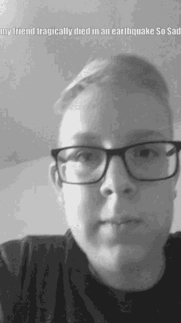 a black and white photo of a man wearing glasses