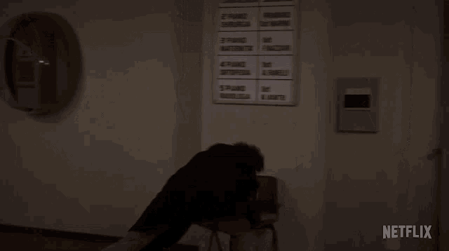 a netflix logo can be seen on the corner of a wall