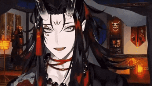 a man with horns is smiling in a room with a samurai statue in the background .