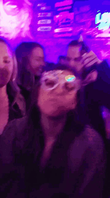 a blurry photo of a woman wearing a mask in a club