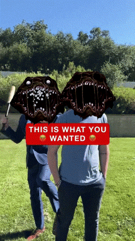 two men are standing in a field with a red sign that says this is what you wanted