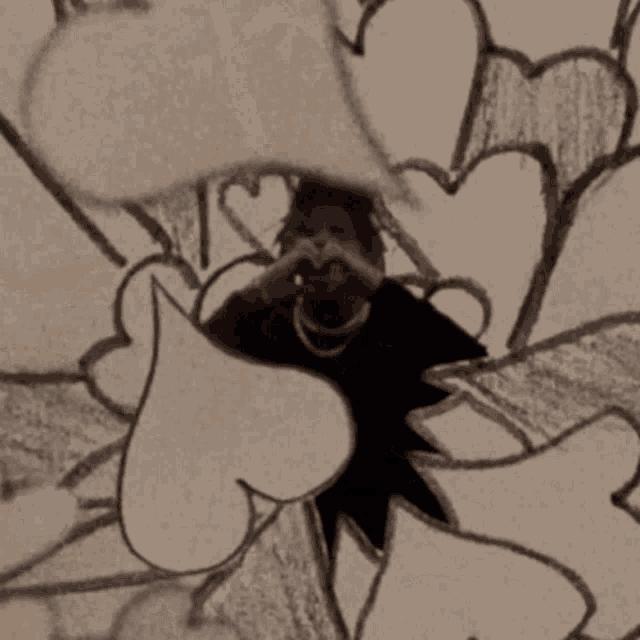 a man is taking a picture of himself in front of a wall with hearts painted on it .