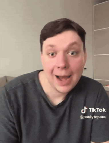 a man wearing a black shirt with a tiktok logo on the sleeve