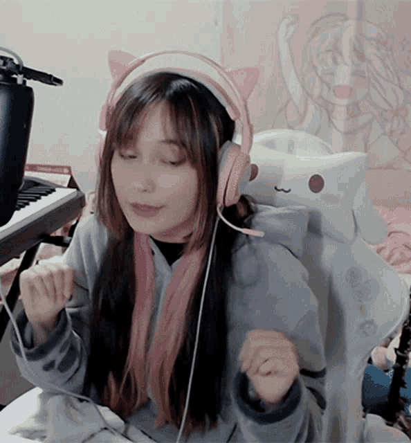 a girl wearing pink headphones with cat ears