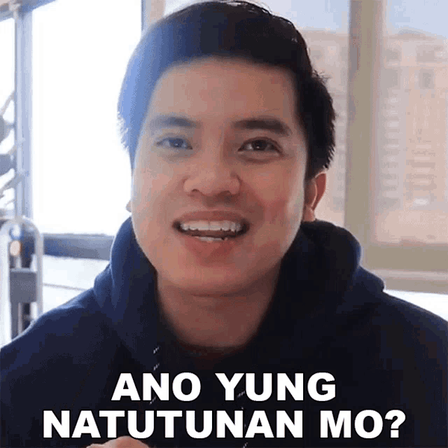 a man in a black hoodie is smiling and says ano yung natutunan mo ?