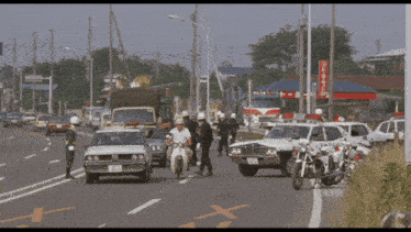 a busy street with cars and motorcycles and a sign that says ' toyota ' on it