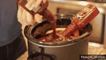 a person is pouring ketchup into a crockpot