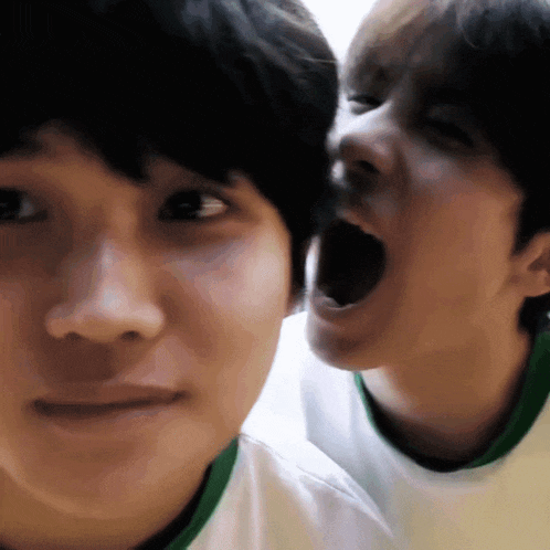 a close up of two people 's faces with one making a funny face