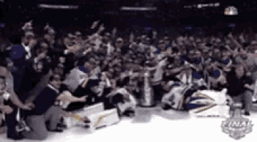 a group of hockey players are posing for a picture with a trophy