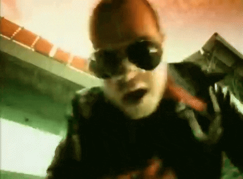 a close up of a man wearing sunglasses and a mask .