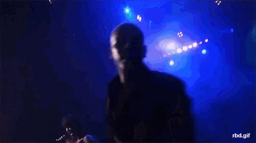 a man singing into a microphone with rbd.gif written on the bottom