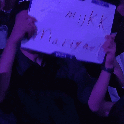 a person is holding a piece of paper that says " mykk marrymel "