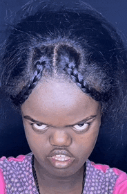 a girl with braided hair is making a very angry face