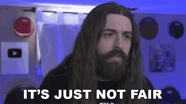 a man with long hair and a beard saying it 's just not fair