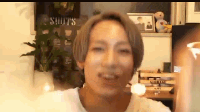a man with short hair is smiling and looking at the camera .