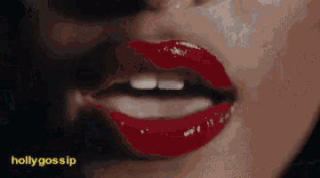 a close up of a woman 's lips with red lipstick