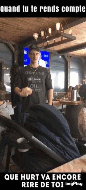 a man wearing a genuine oil shirt is standing in a restaurant