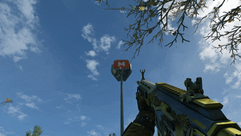 a person holding a gun in front of a sign that says m