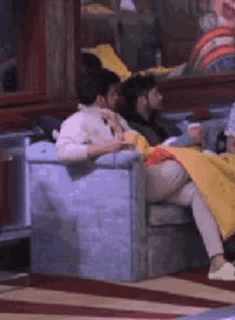 a group of people are sitting on chairs in a living room .