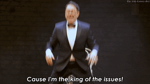 a man in a tuxedo and bow tie is dancing and says cause i 'm the king of the issues