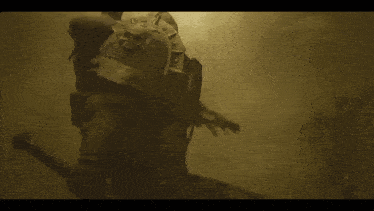 a statue with a skull on it is surrounded by fog