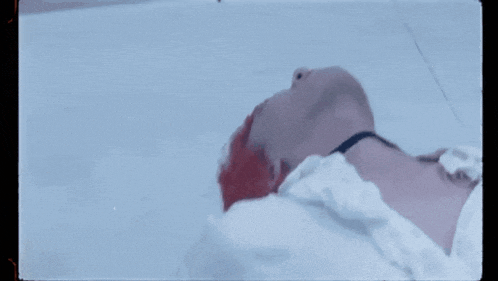a person with red hair is laying on the floor