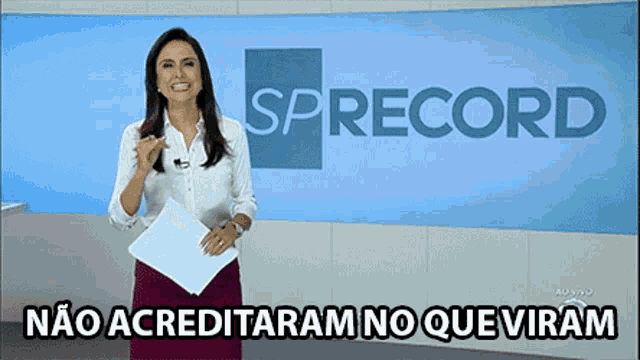 a woman stands in front of a screen that says ' sprecord ' on it
