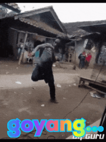 a picture of a man dancing with the word goyang on the bottom right
