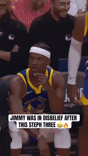 a golden state warriors basketball player sitting in the stands