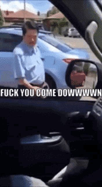 a man in a car with the words " fuck you come dowwwwn " on it