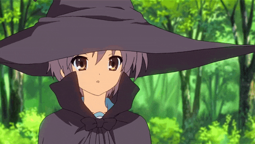 a girl in a black witch hat and cape