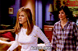 two women are standing next to each other and one of them is saying back off
