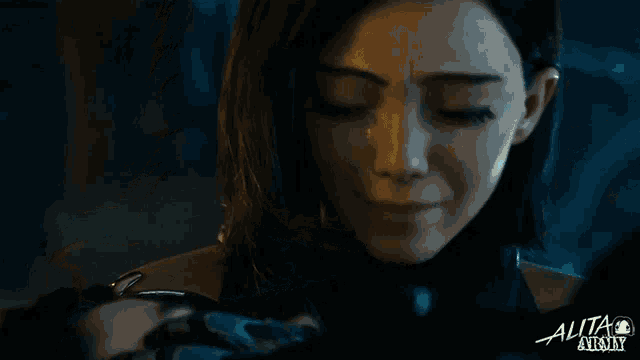 a close up of a woman 's face with the word alita at the bottom right