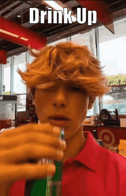 a young man drinking a soda with the words drink up written above him