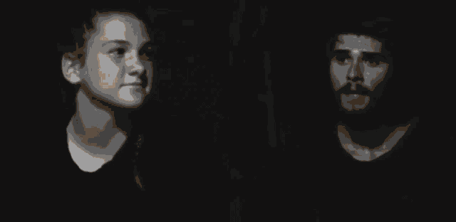 a blurry photo of a man and a woman in a dark room