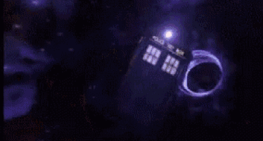 a blurred image of a police box with a pink light behind it