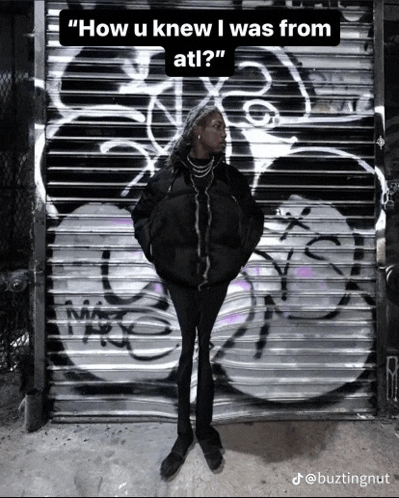 a person standing in front of a graffiti wall with the caption " how u knew i was from at ! "