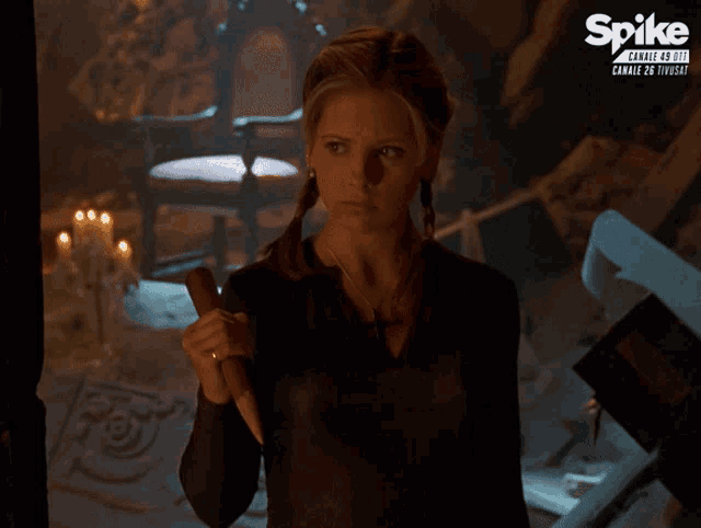 a woman is holding a knife in front of a spike channel
