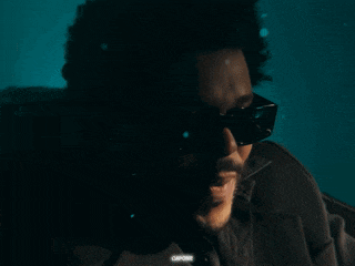 a close up of a man wearing sunglasses and a jacket that says capone