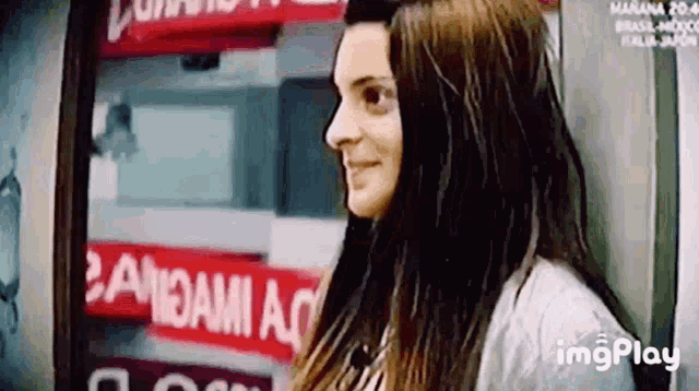a woman is standing in front of a sign that says bandami