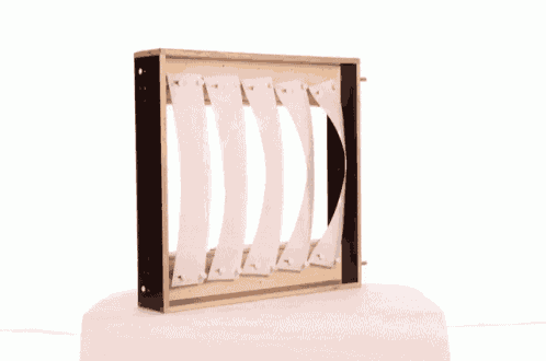 a wooden box with a black frame and white stripes on it