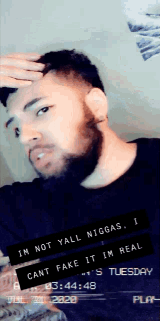 a man with a beard is taking a selfie and says im not yall niggas
