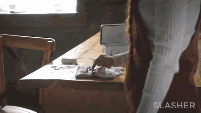 a person cleaning a table with the word slasher on the bottom right